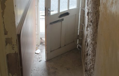 Entrance hall with cement render partly removed from one wall #ReadyForRain 33a Chapel St