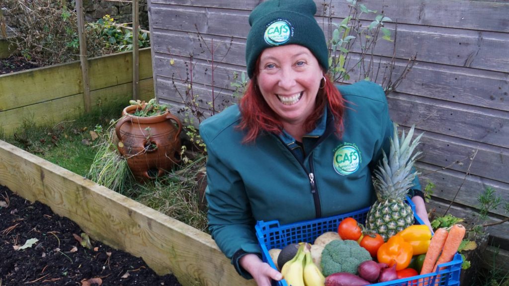 Roe Baker from CAfS by a veg bed, as Alston Moor food-growing study launched