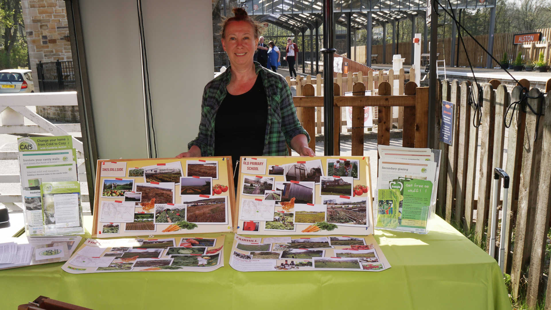 Roe Baker from CAfS running a stall at South Tynedale Railway Earth Day showing photos of options for food growing on Alston Moor