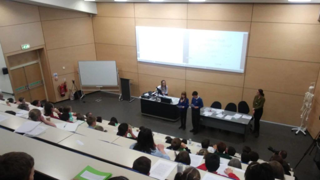 Young people in a lecture theatre listening as two students give a presentation on their fears about climate change, at Cumbria's first youth climate summit in Carlisle in April 2019
