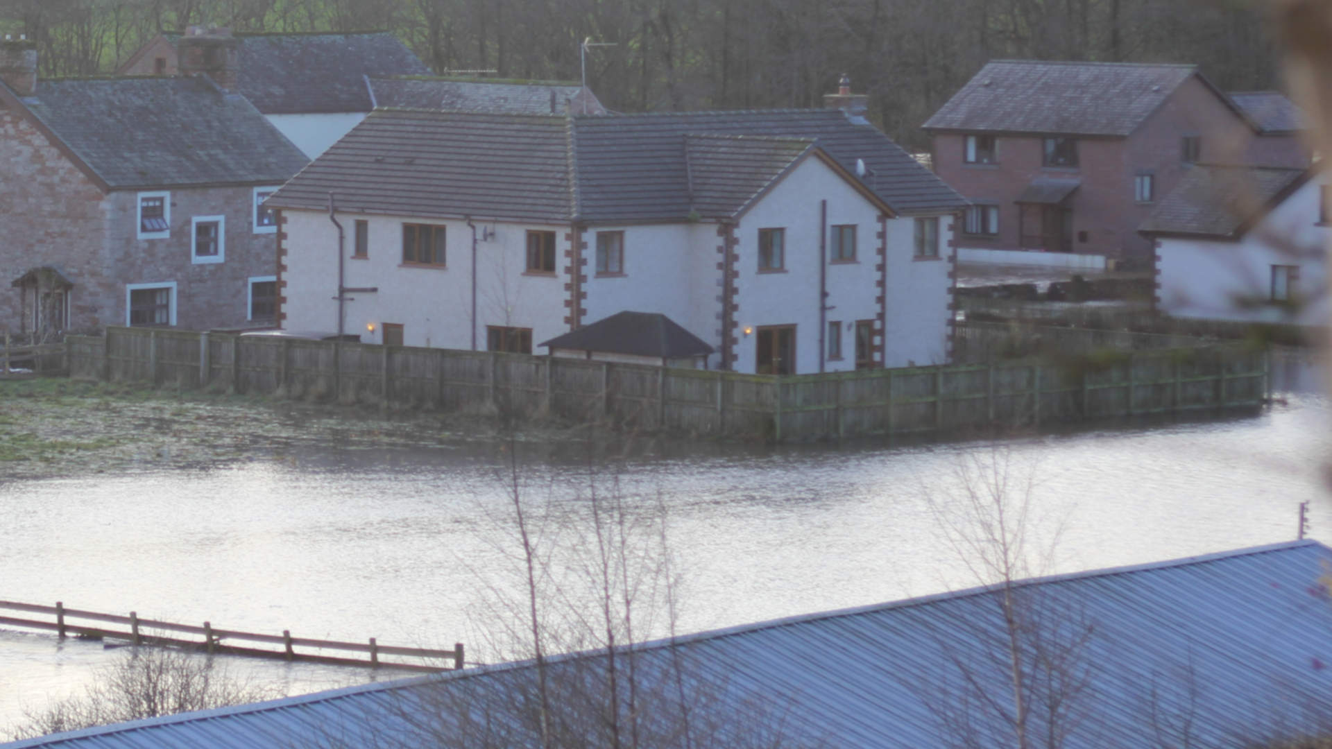 Houses at Eamont Bridge near Penrith surrounded by flood water during Storm Desmond Dec 2015