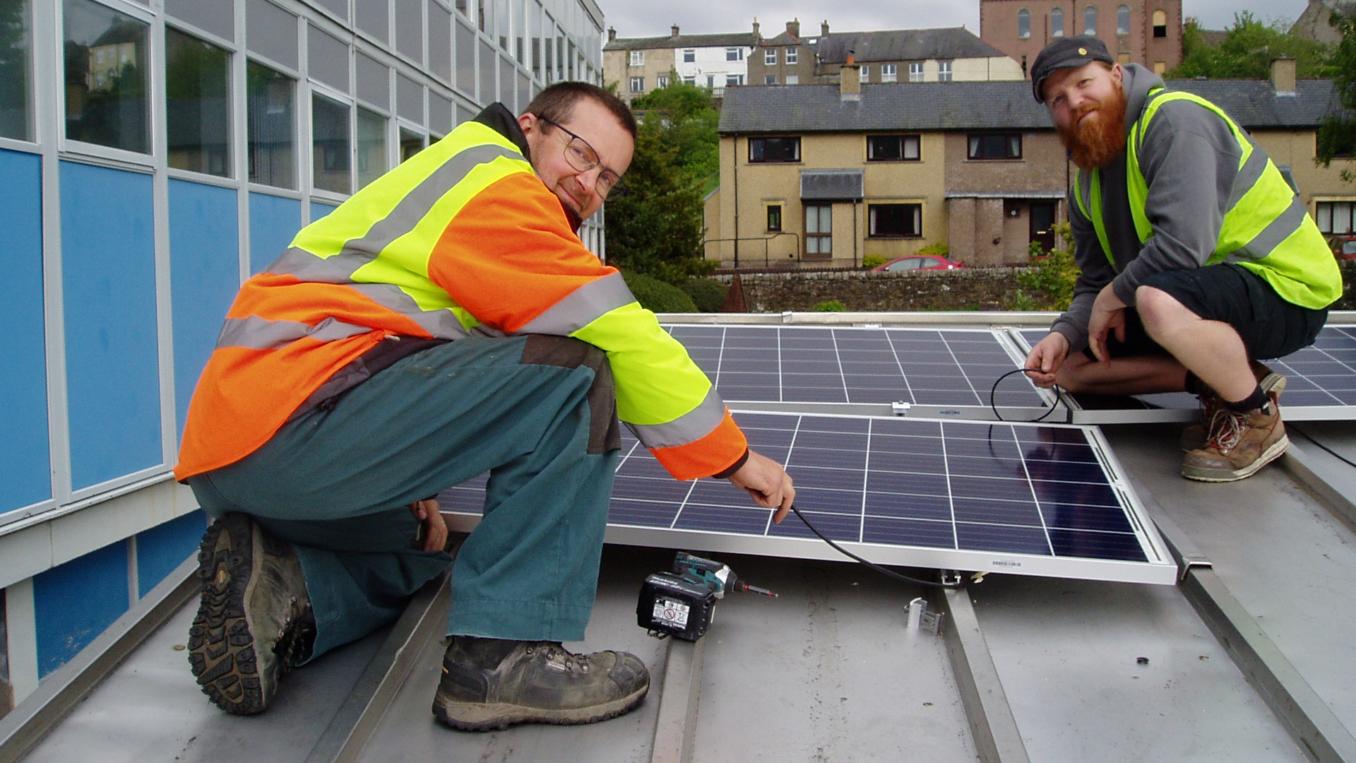 Keith Hodgson and Keir Marsden from Love Solar Ltd installing the solar PV panels on the roof of Alston schools