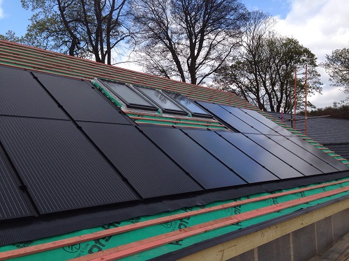 Solar panels on the roof of a straw bale new-build home at Brampton