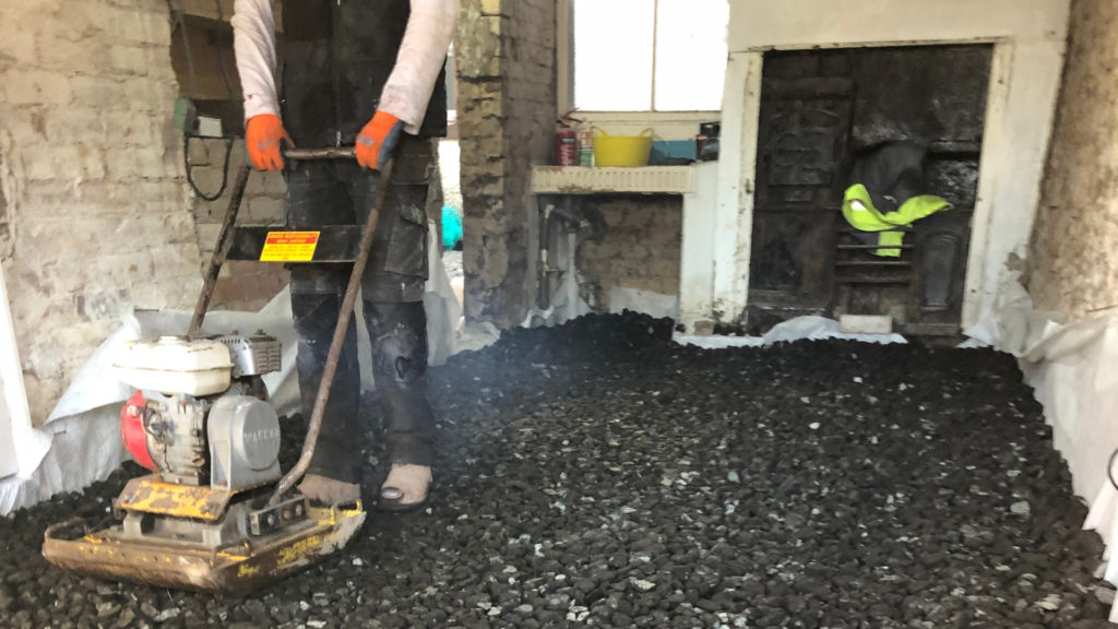 Installing the insulation layer of a limecrete floor at 33a Chapel St in Appleby