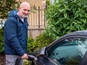 man charging electric car