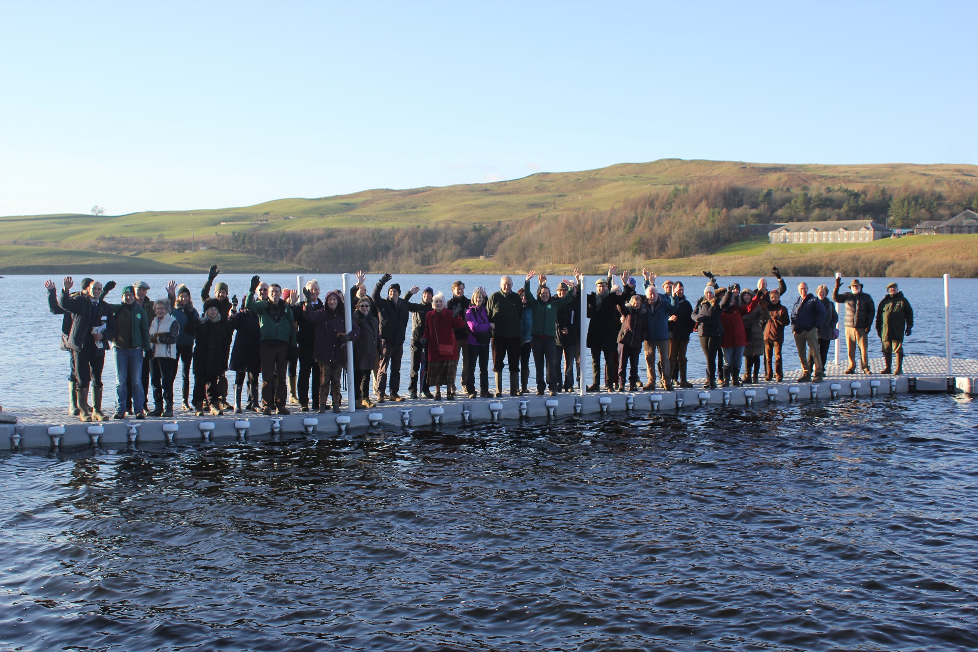 Members of Community Energy Cumbria celebrate the official launch of their hydro scheme at Killington Reservoir
