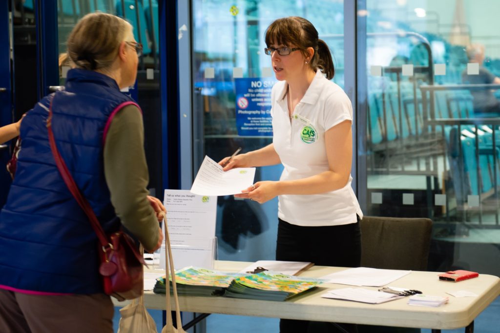 CAfS administrator Kushti Morsman checking in an attendee at an event