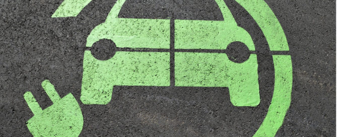 Electric vehicle charging icon on tarmac