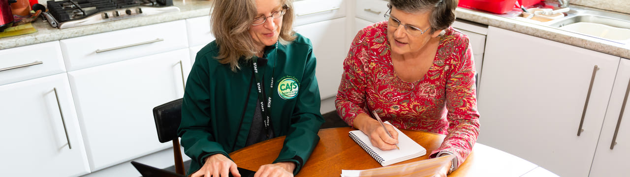 Tina from CAfS helping a Cold to Cosy Homes client to look for a cheaper tariff for energy bills