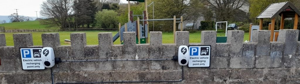 Two charging sockets on a low wall