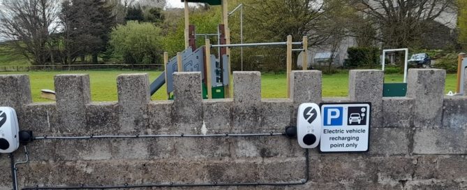 Two charging sockets on a low wall