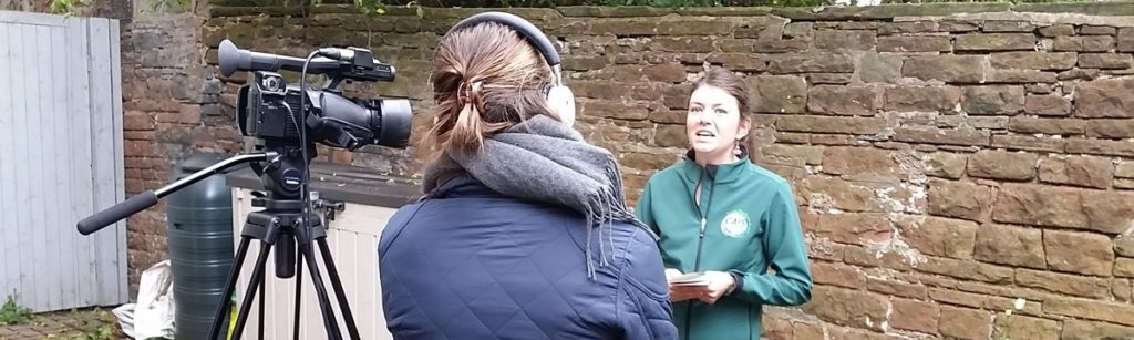 A CAfS team member being interviewed by a TV reporter on carmera