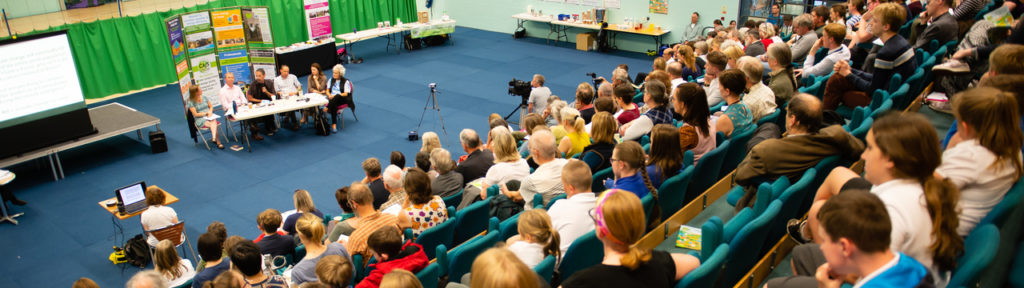 Audience watching a panel of activists and politicians