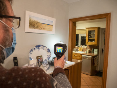 A thermal imaging camera being used to assess heat loss from a house.