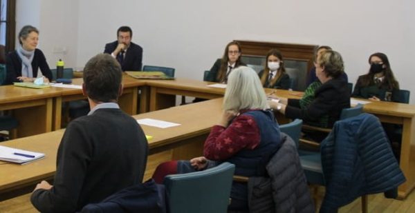 Young people discussing climate with councillors at a table