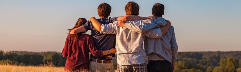 Young people embracing in a field