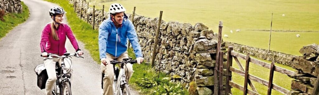 Two people cycling in the lakes