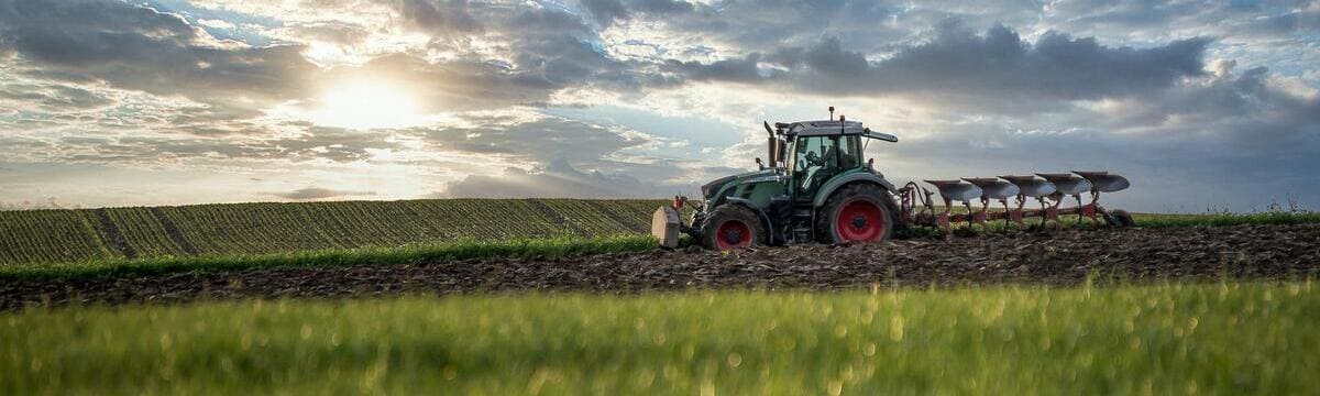Tractor ploughing across the horizon