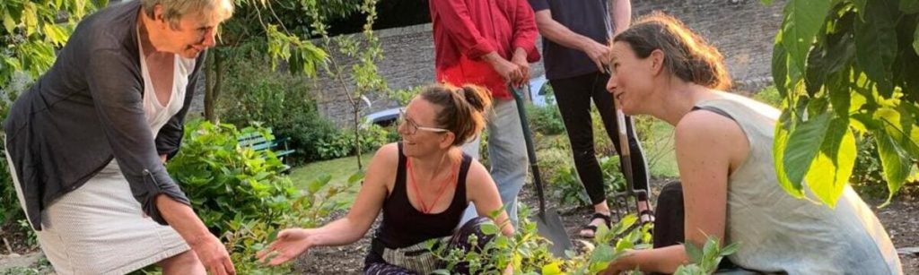 Community garden in Greysouthen with people tending the garden